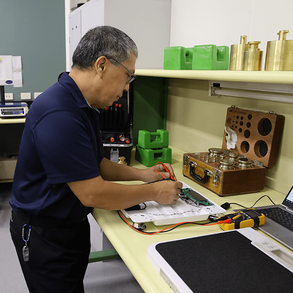 Wedderburn service and maintenance staff repairing scale
