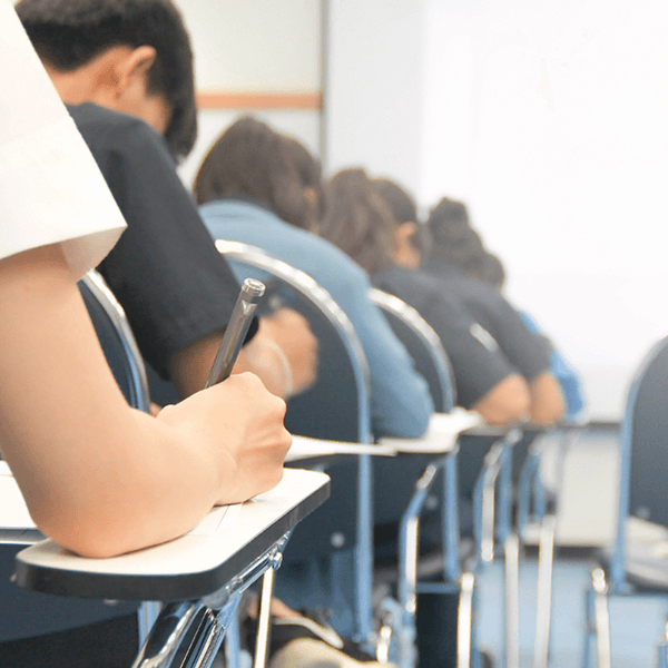 female student writing in university